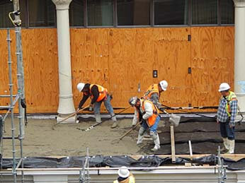 Chamberlin's workers waterproofing balcony deck