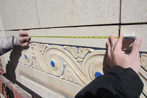 Hands holding ruler doing thorough inspection of a building in Oklahoma City