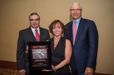 Chamberlin's group of three stand receiving ENR Regional Best Project award